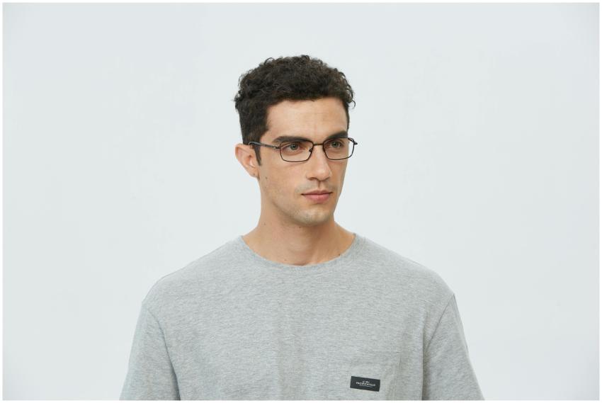 Portrait of a young man wearing glasses and a gray