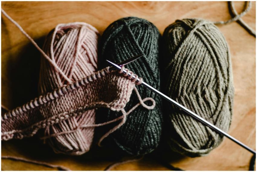 Close-up of vibrant yarn balls and knitting needle