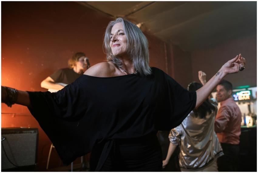 A joyful woman dancing in a lively nightclub scene