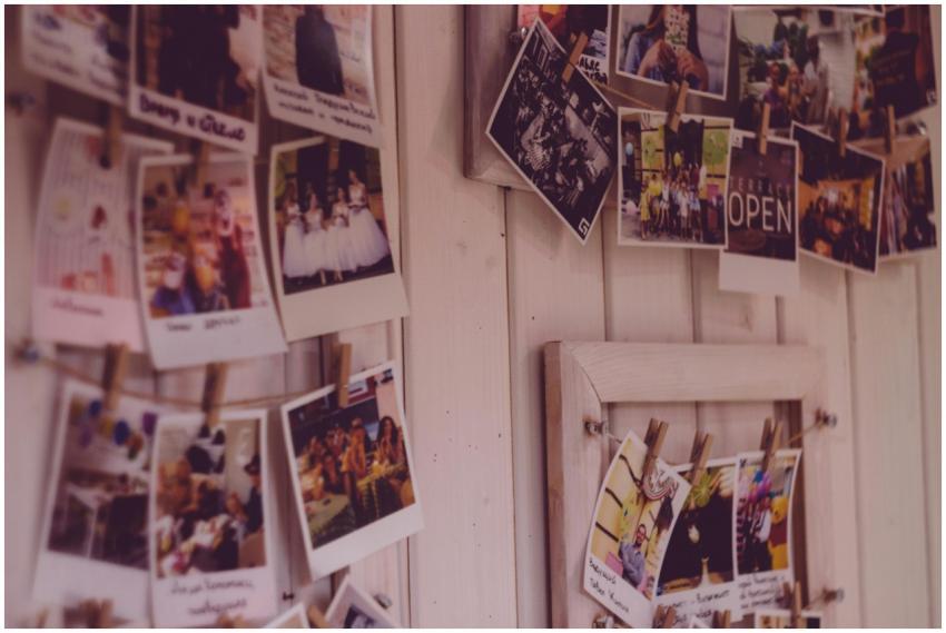 Collection of vintage Polaroid photos clipped to a