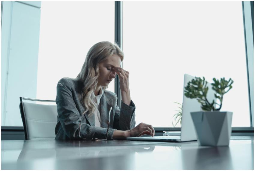 Professional woman in office, sitting at desk, loo