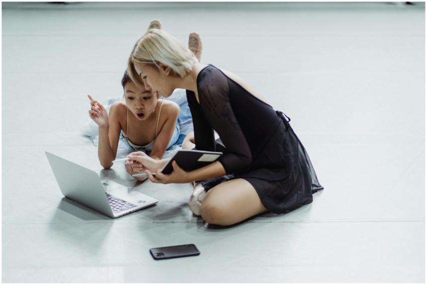 Two female ballet dancers engaged in online learni