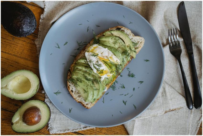Healthy avocado toast topped with poached egg and