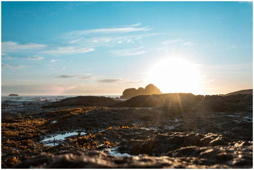 Vibrant sunrise illuminating a rocky seashore with