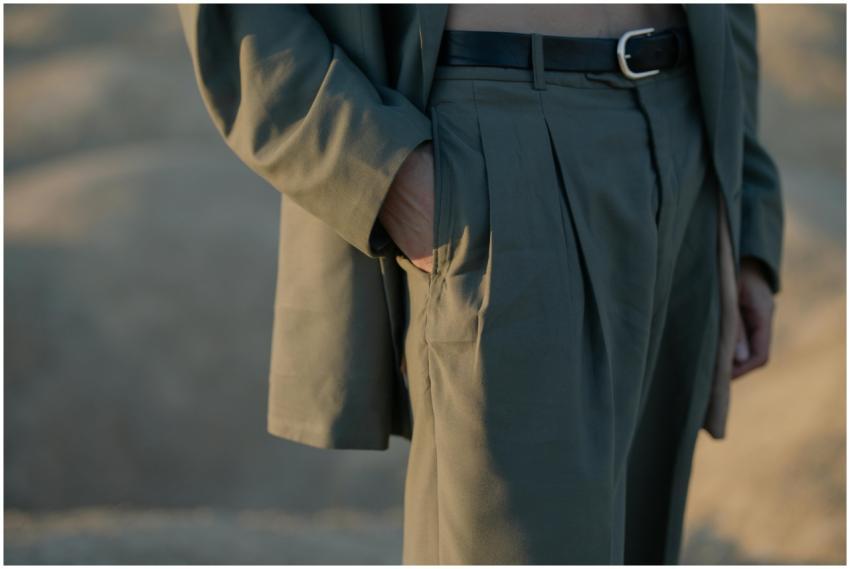 Close-up of a man in a suit in a desert, showcasin