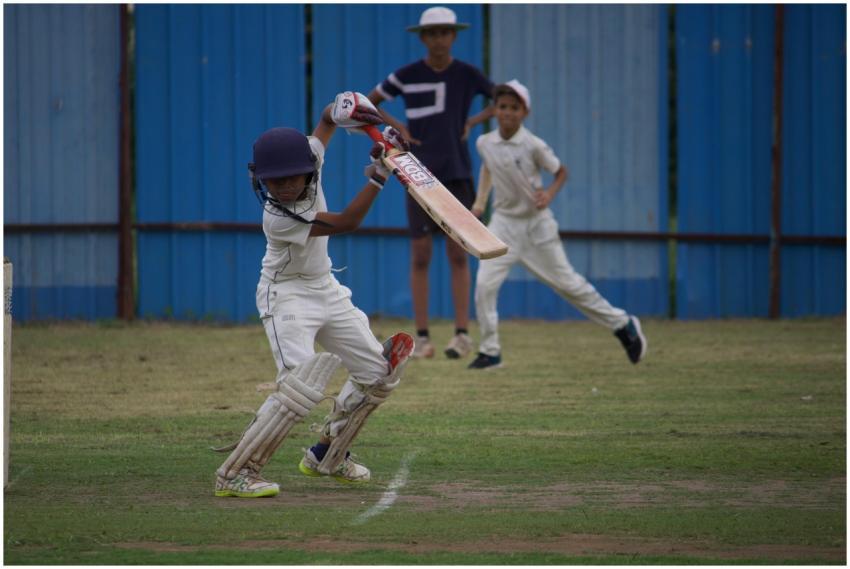 Young boys playing a competitive cricket match at