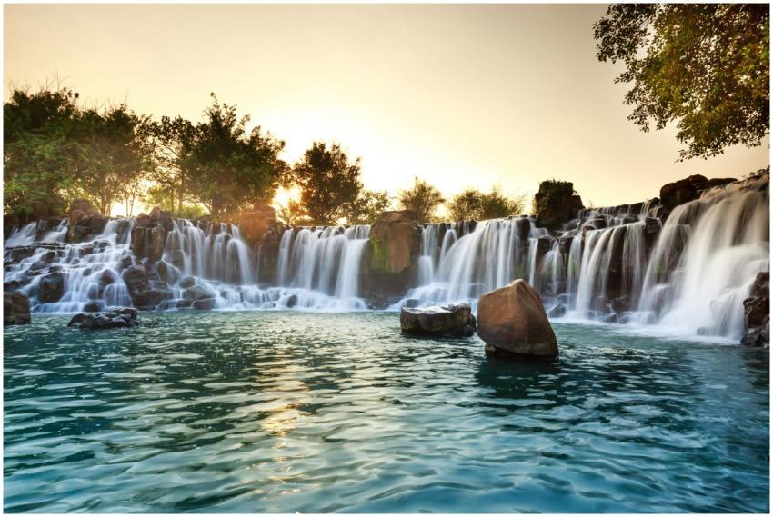 A serene waterfall surrounded by rocks and trees a