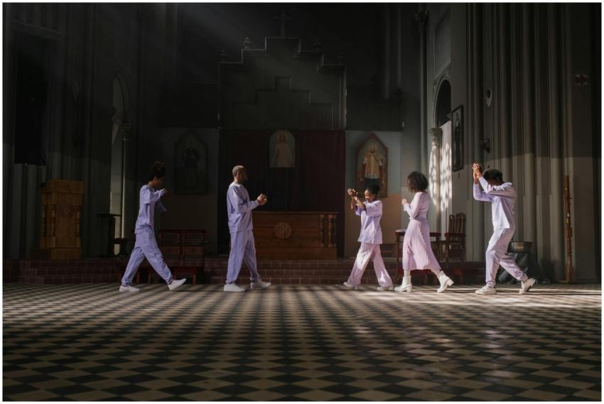 A diverse group of people practicing a choreograph