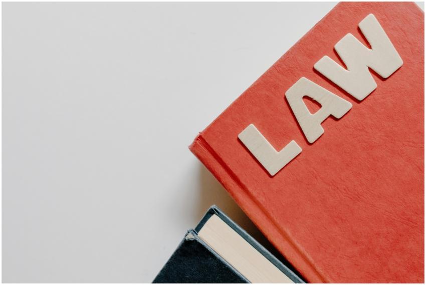 Red law textbook and dark book on white background
