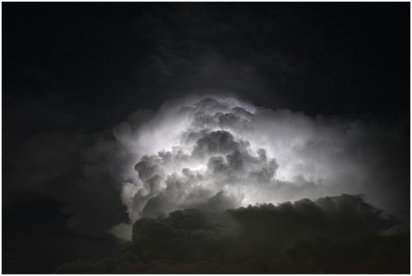 Powerful lightning illuminates dark storm clouds a