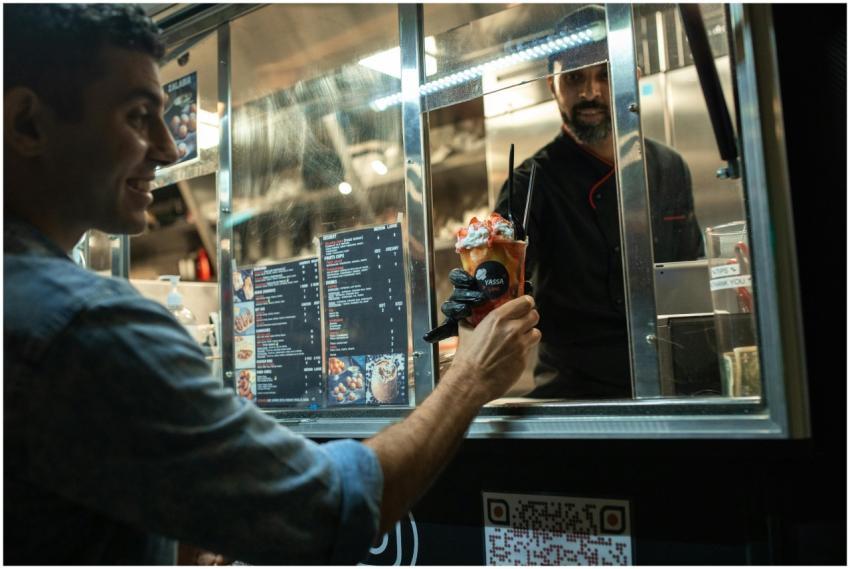 Man receiving a delicious dessert from a food truc