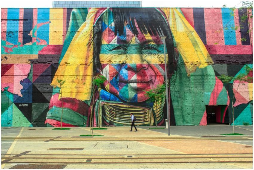 Colorful mural depicting a native face on an urban