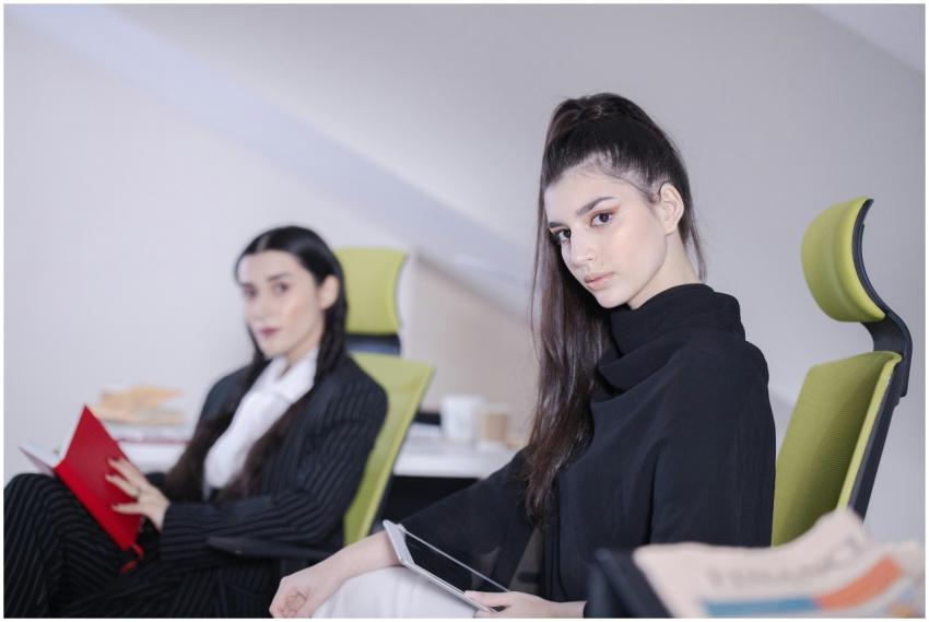 Two businesswomen sitting in a modern office with
