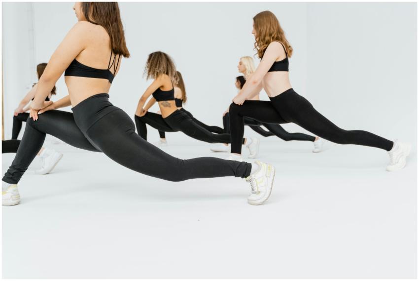 Women in black leggings performing stretching exer