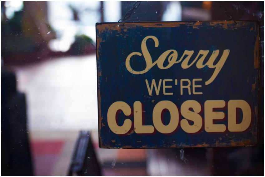 A rustic 'Sorry We're Closed' sign displayed on a
