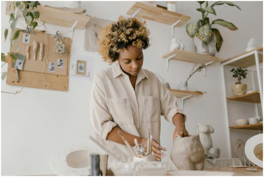 Creative artisan shaping clay in a serene workshop
