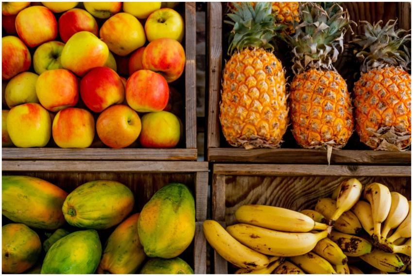 Colorful display of apples, pineapples, bananas, a