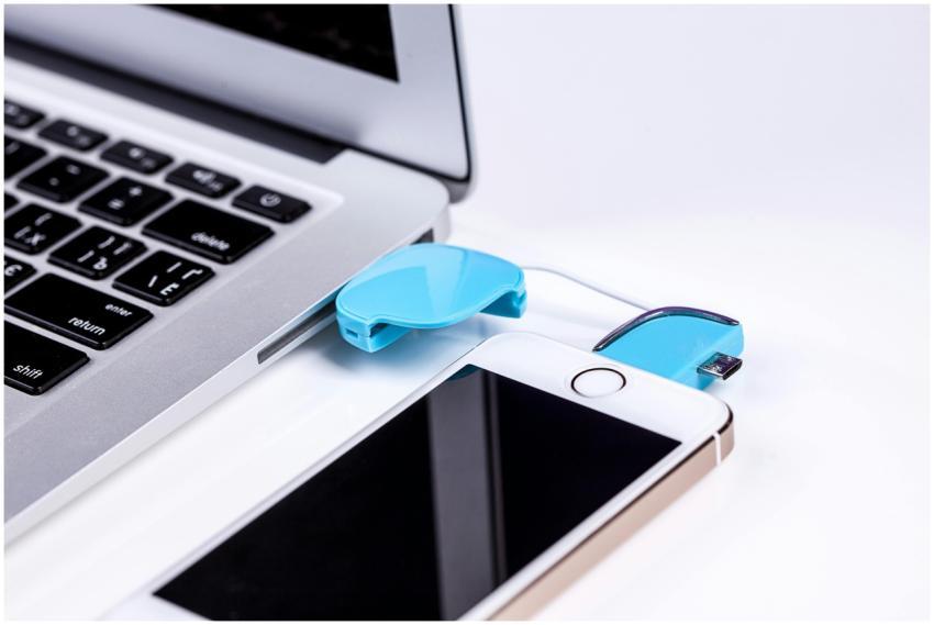 Close-up of a laptop and smartphone connected via