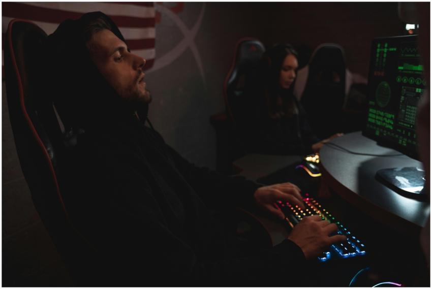 Young adults working on cybersecurity tasks in a d