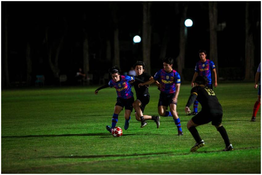 Action-packed night soccer match with players comp