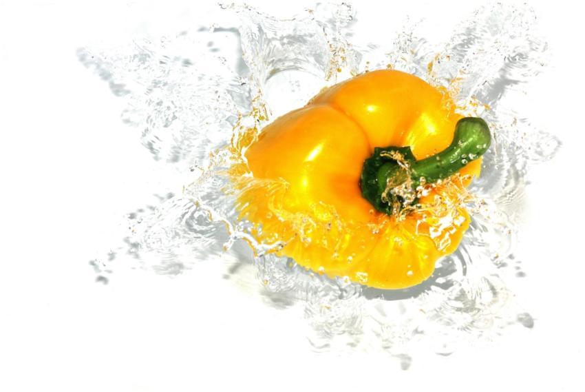 A striking image of a yellow bell pepper splashing