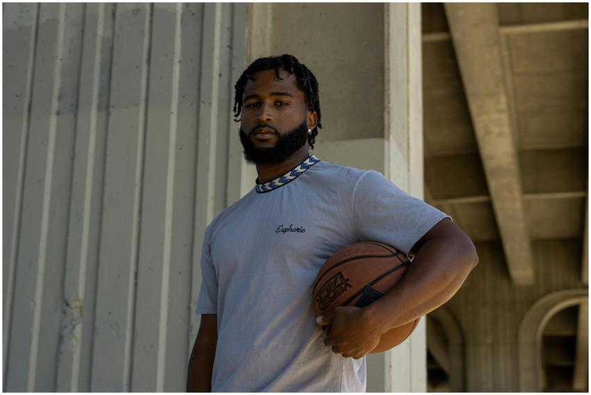 Portrait of a man with dreadlocks holding a basket