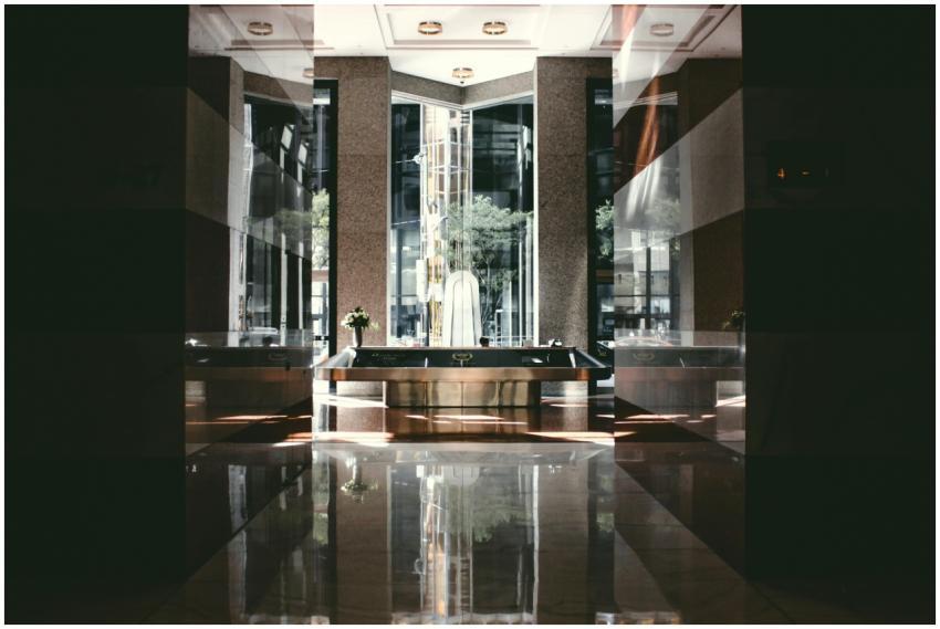 A sophisticated modern hotel lobby with glossy flo