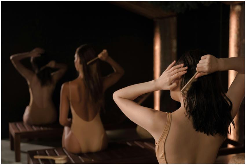 Three women in swimwear combing their hair in a se