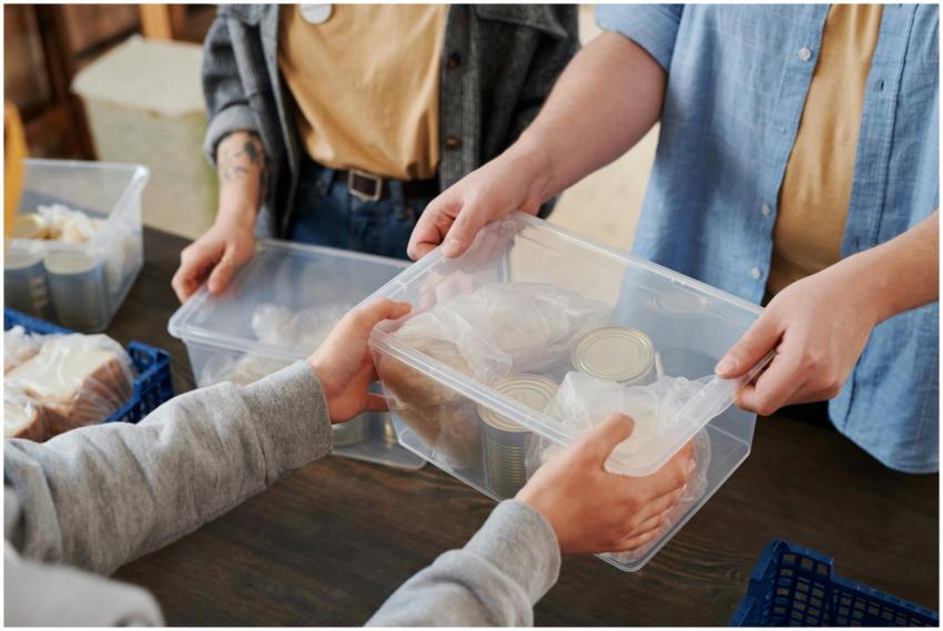 Close-up of volunteers distributing food packages