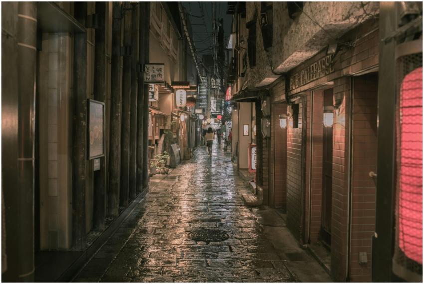 Moody urban street scene at night in a narrow Osak