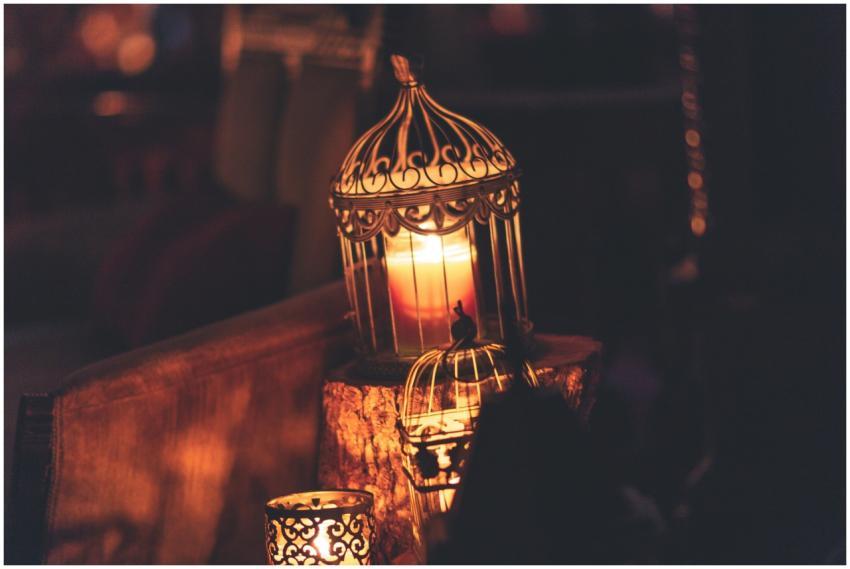 A glowing candle inside an ornate lantern creates