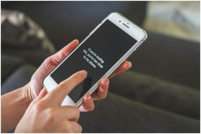 Person interacting with a smartphone indoors, emph