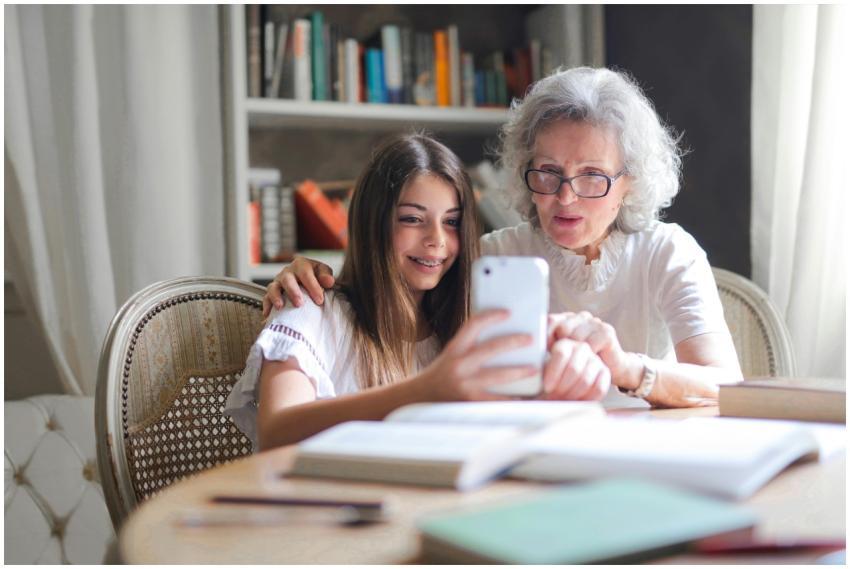 A grandmother and granddaughter bonding over a sma
