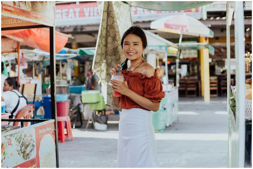 Cheerful woman holding a drink, enjoying her time