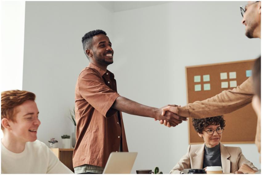 Business team members shaking hands during a meeti