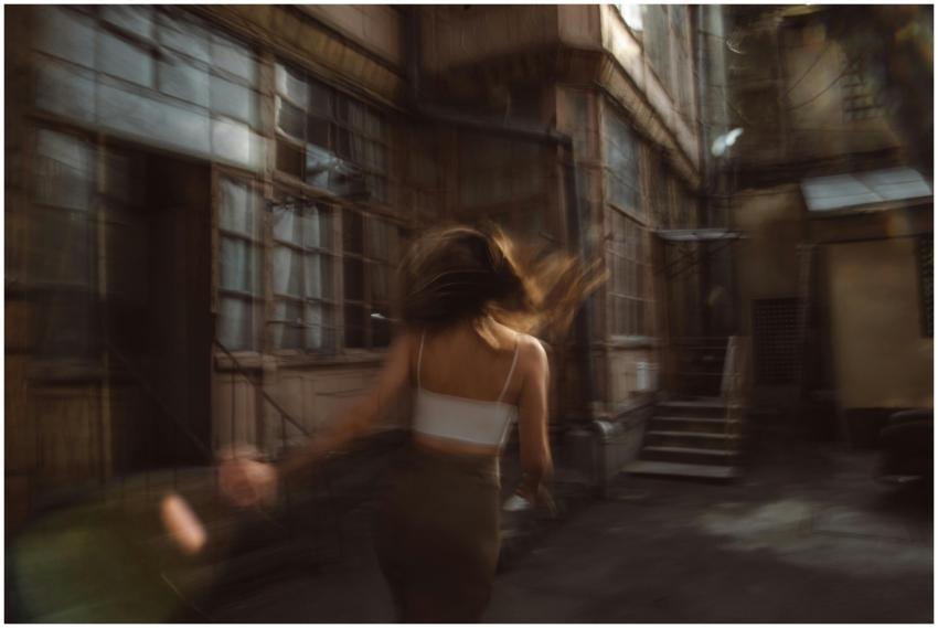 Artistic shot of a woman in motion with blurred ba