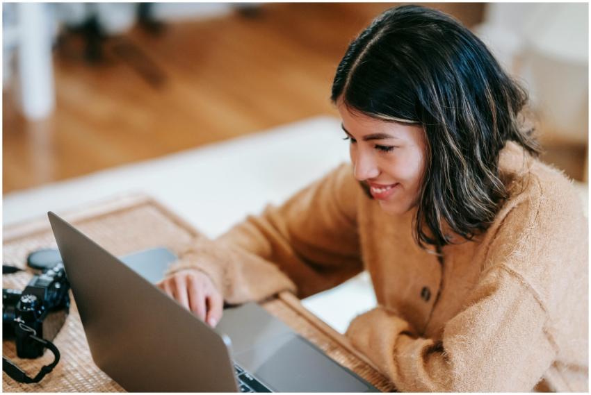 Smiling Latin American female remote employee work