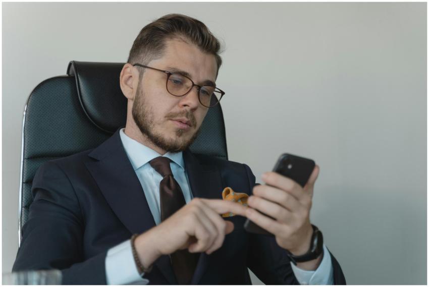 Professional businessman in a formal suit using hi