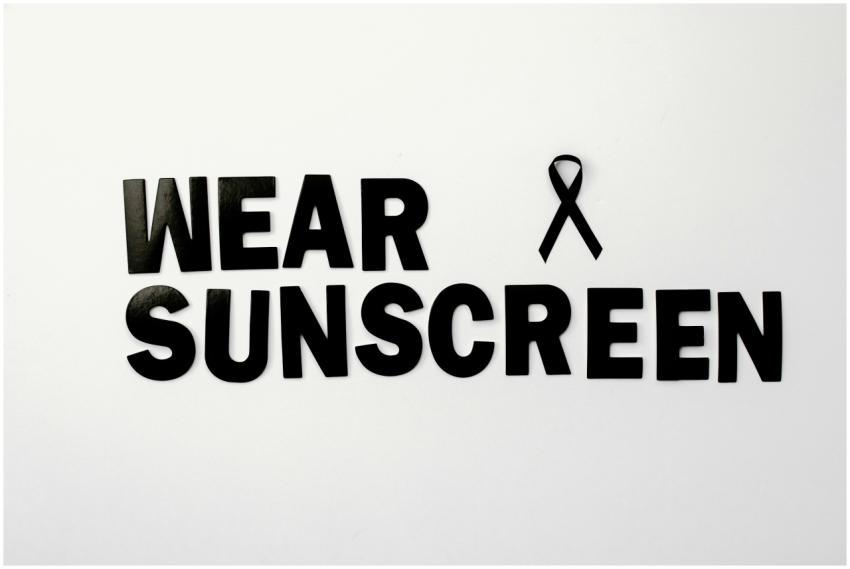 Black text and ribbon promoting skin cancer awaren