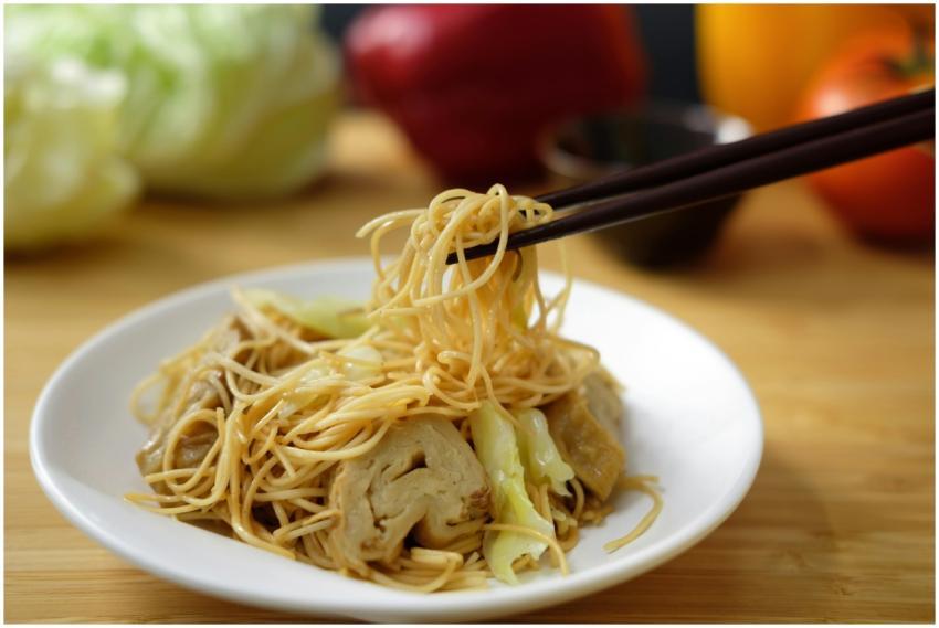 Tasty Asian noodles and vegetables served with cho