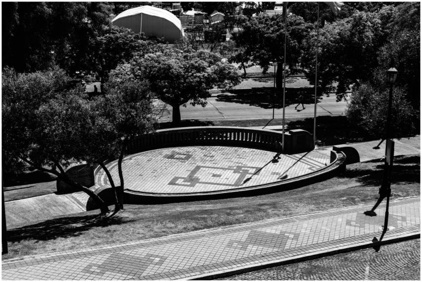 A high-contrast black and white image of an urban