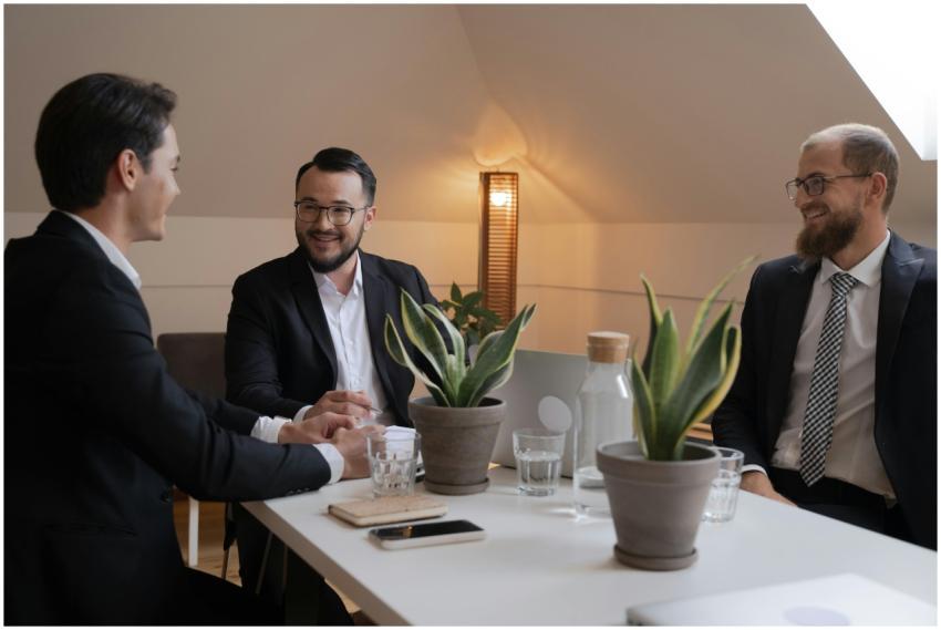 Three businessmen in suits engaged in a positive o