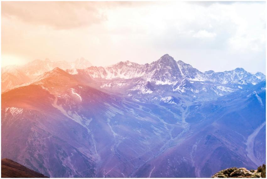 Breathtaking view of snow-covered mountains at sun