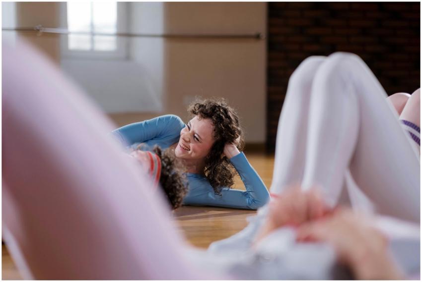 Smiling woman in blue top lying on floor during da