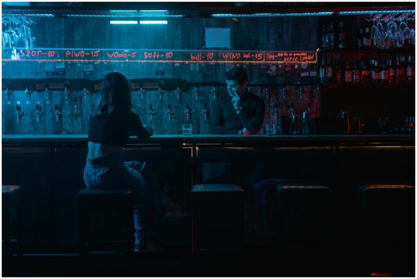 Moody night shot of a bar setting with neon lights