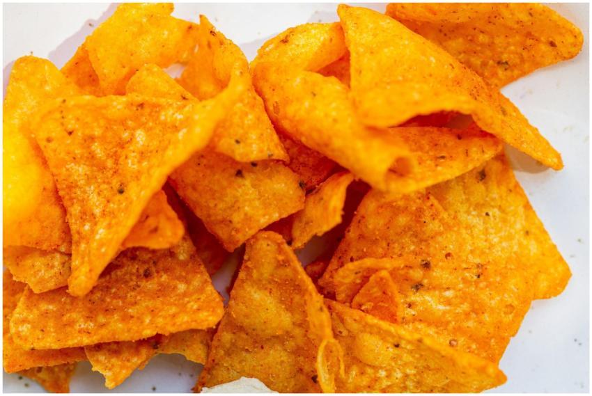 High-angle view of seasoned nacho chips with visib