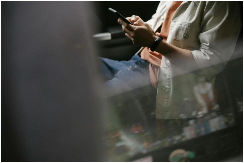 Casual man texting on smartphone while traveling a