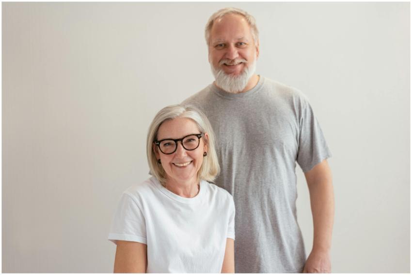 Cheerful senior couple smiling indoors, capturing
