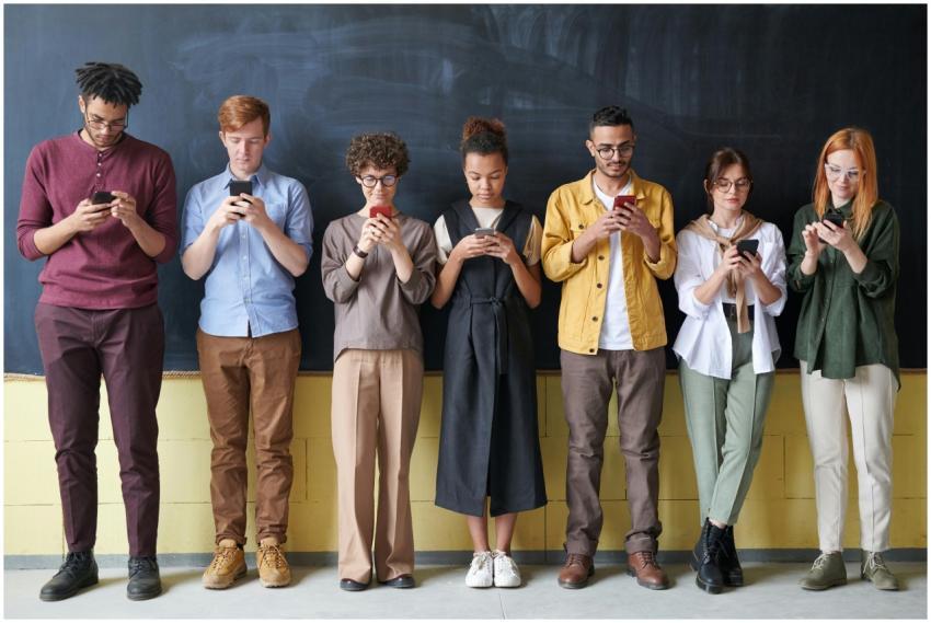 A diverse group of adults standing in a row, engag