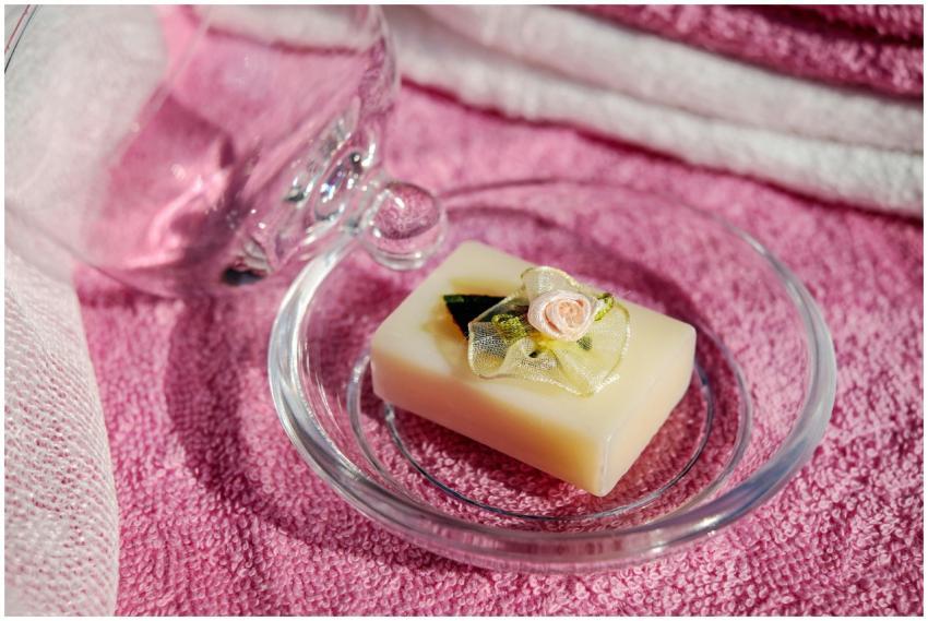 Elegant soap bar with floral decor on a pink towel